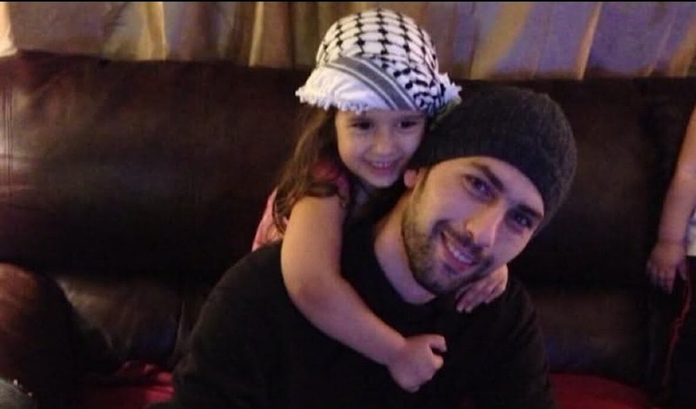 Palestinian-American Khamis Ayyad with his daughter in an undated photograph (Social Media)