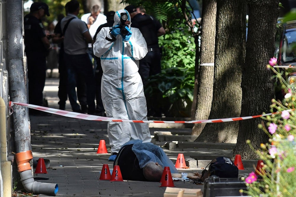 A forensic expert photographs a body of a former Ukrainian parliament speaker Andriy Parubiy, in Lvov, Ukraine, Saturday, Aug. 30, 2025 (AP)