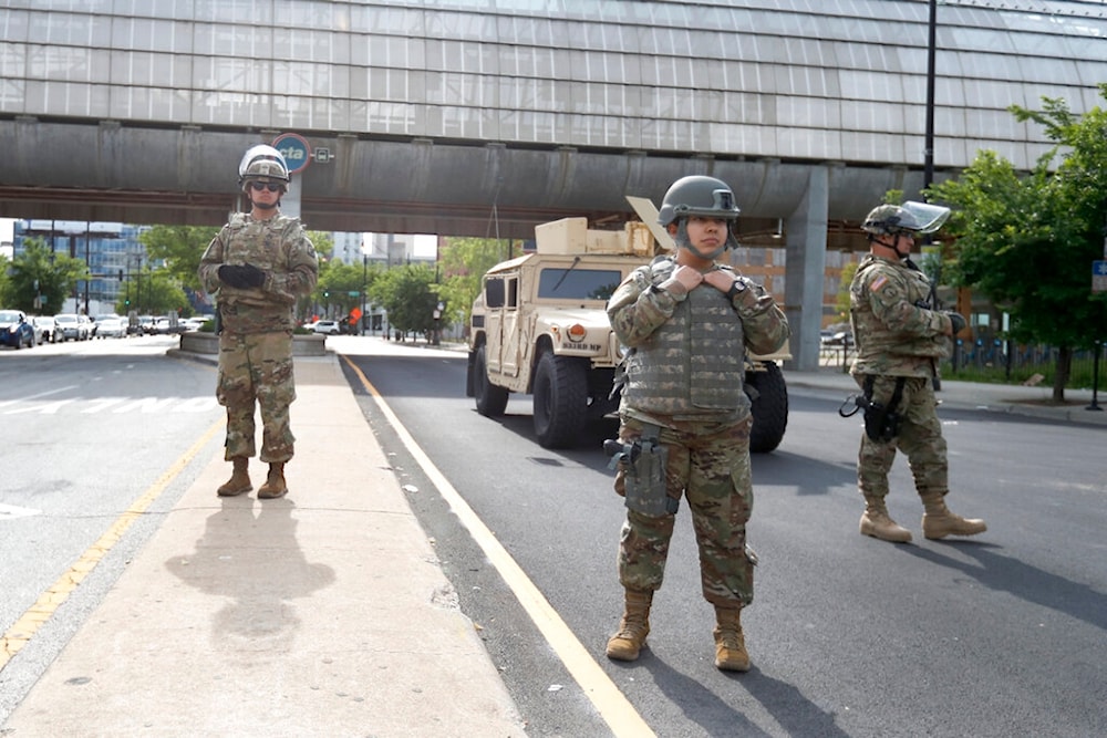 Members of an Illinois National Guard Military Police stand a post, Monday, June 1, 2020, at a security perimeter on Chicago's near Southside. (AP Photo/Charles Rex Arbogast)