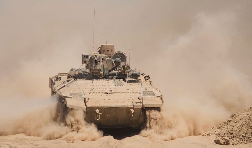 Israeli soldiers drive on their armored personnel carrier back from inside the northern Gaza Strip, Tuesday, July 29, 2025. (AP)