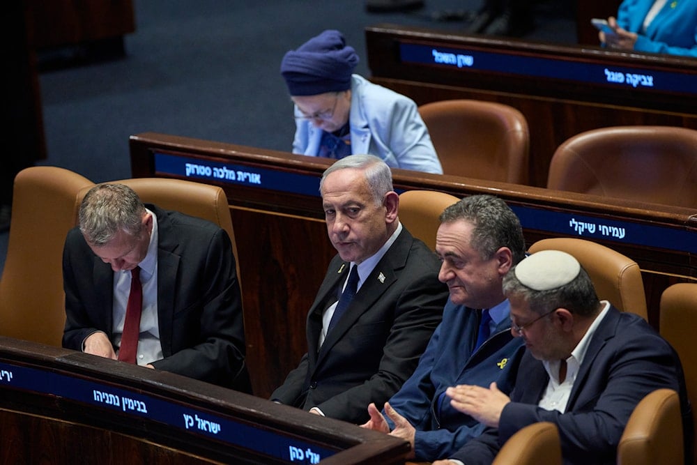 Israeli Prime Minister Benjamin Netanyahu, surrounded by ministers from the government attends a session of the Knesset, al-Quds, Monday, July 14, 2025 (AP)