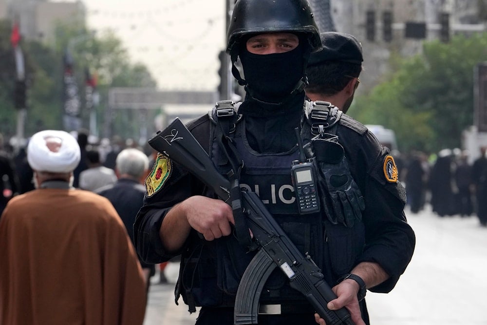 An Iranian police officer stands guard during the funeral ceremony of Hamas leader Ismail Haniyeh and his bodyguard, at Azadi (Freedom) St. in Tehran, Iran, Thursday, Aug. 1, 2024 (AP)