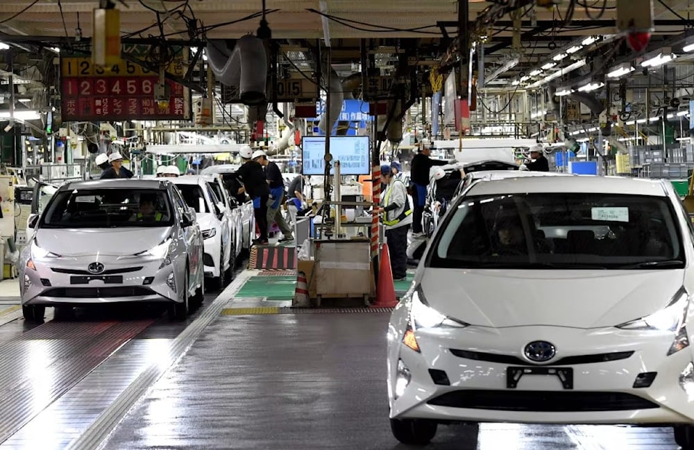 Toyota Prius cars are driven from the production line at the company’s Tsutsumi assembly plant in Toyota City, Japan, in 2018. (AFP/Getty Images)