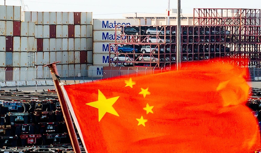 A Chinese flag waves on a ship at the port of Oakland, California, on Tuesday, April 15, 2025. (AP Photo/Noah Berger)