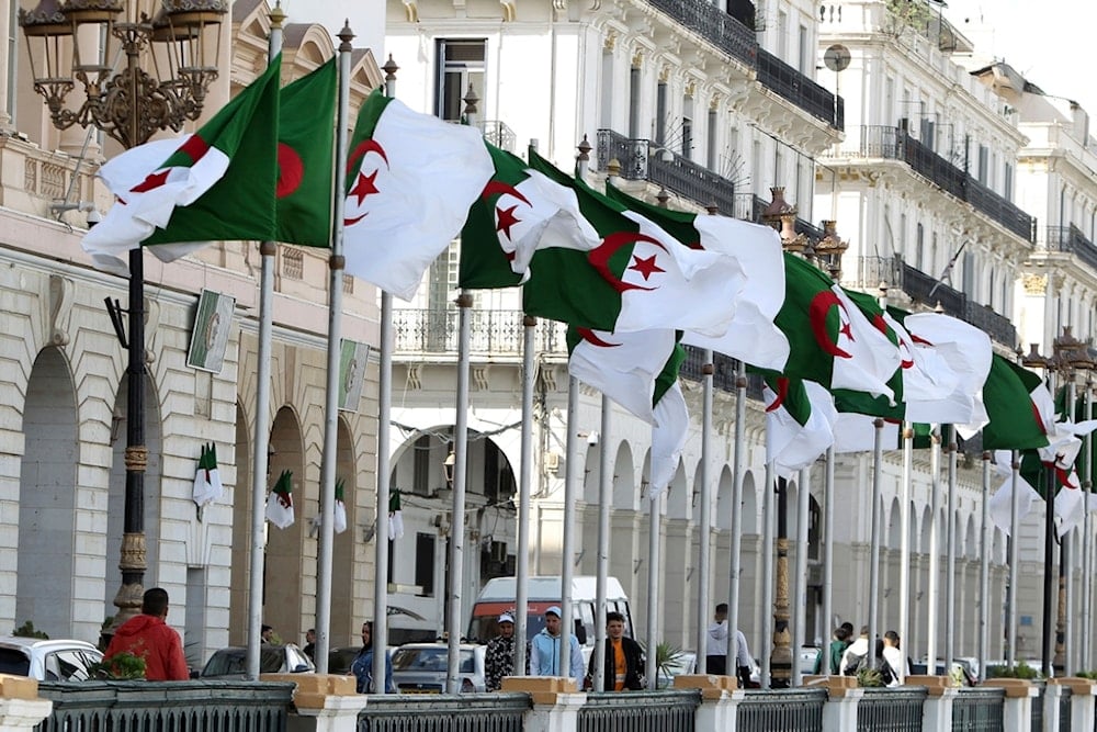 FILE - Algeria's flags fly Wednesday, April 16, 2025 in Algiers. (AP Photo/Fateh Guidoum, File)
