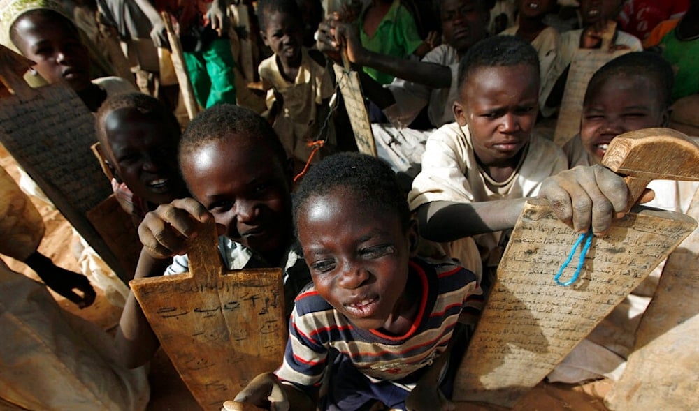In this April 13, 2010 file photo, Sudanese refugee children hold their writing boards while attending a local school in the refugee camp of Zamzam, on the outskirts of El Fasher, Darfur, Sudan. (AP)