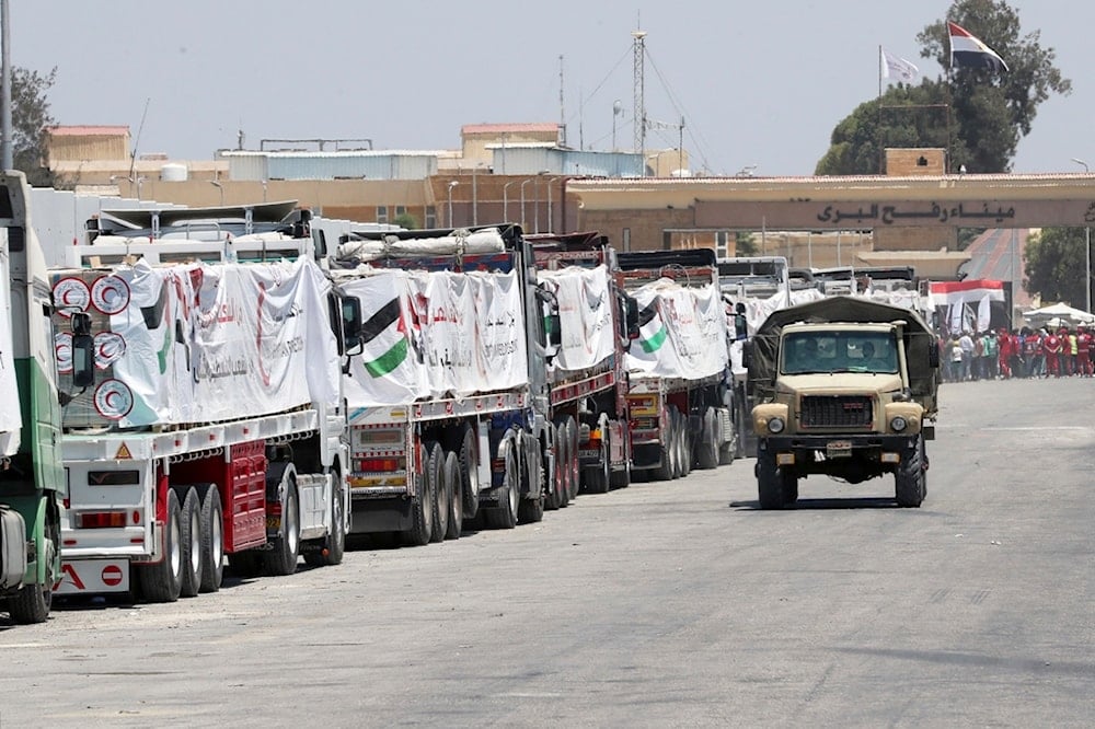 Trucks carrying humanitarian aid, line up as they wait to enter Rafah crossing between Egypt and the Gaza Strip, Wednesday, Aug. 6, 2025. (AP Photo/Khaled Elfiqi)