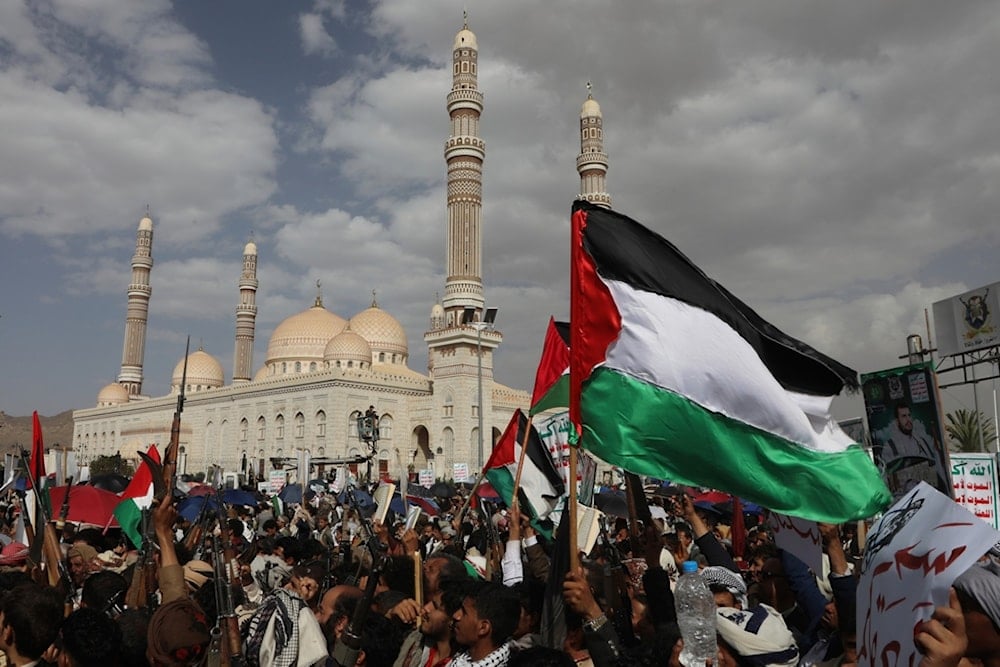 Houthi supporters wave Palestinian flags during a weekly protest against the US and the Israeli occupation in Sanaa, Yemen, Friday, July 11, 2025 (AP)