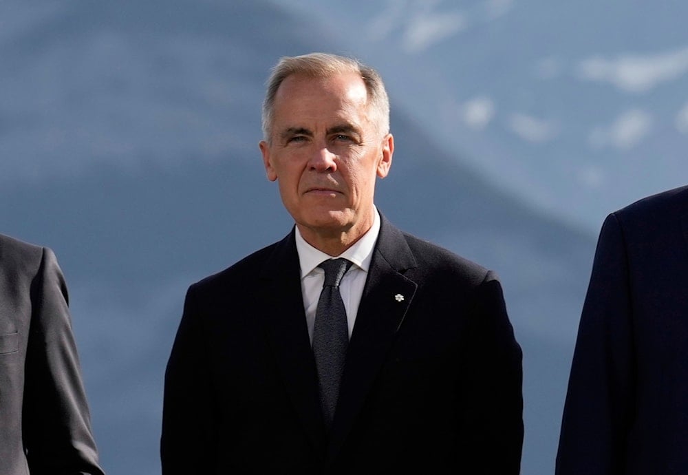 Canada's Prime Minister Mark Carney pose during a group photo at the G7 Summit, Monday, June 16, 2025, in Kananaskis, Canada. (AP Photo/Mark Schiefelbein)