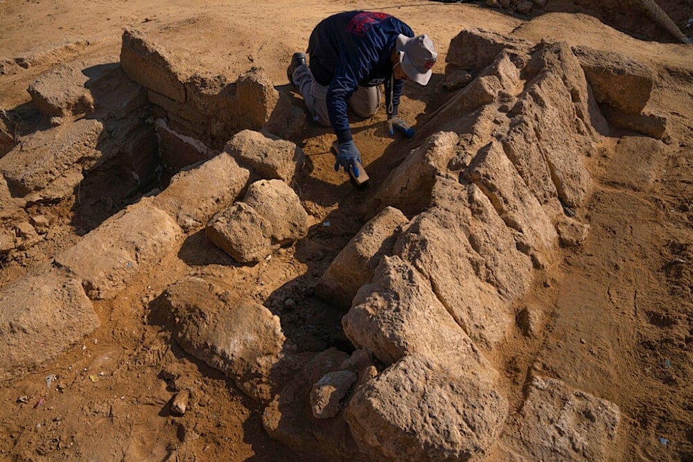 A member of a Palestinian excavation team works in a newly discovered Roman era cemetery in the Gaza Strip, Sunday, December 11, 2022 (AP)