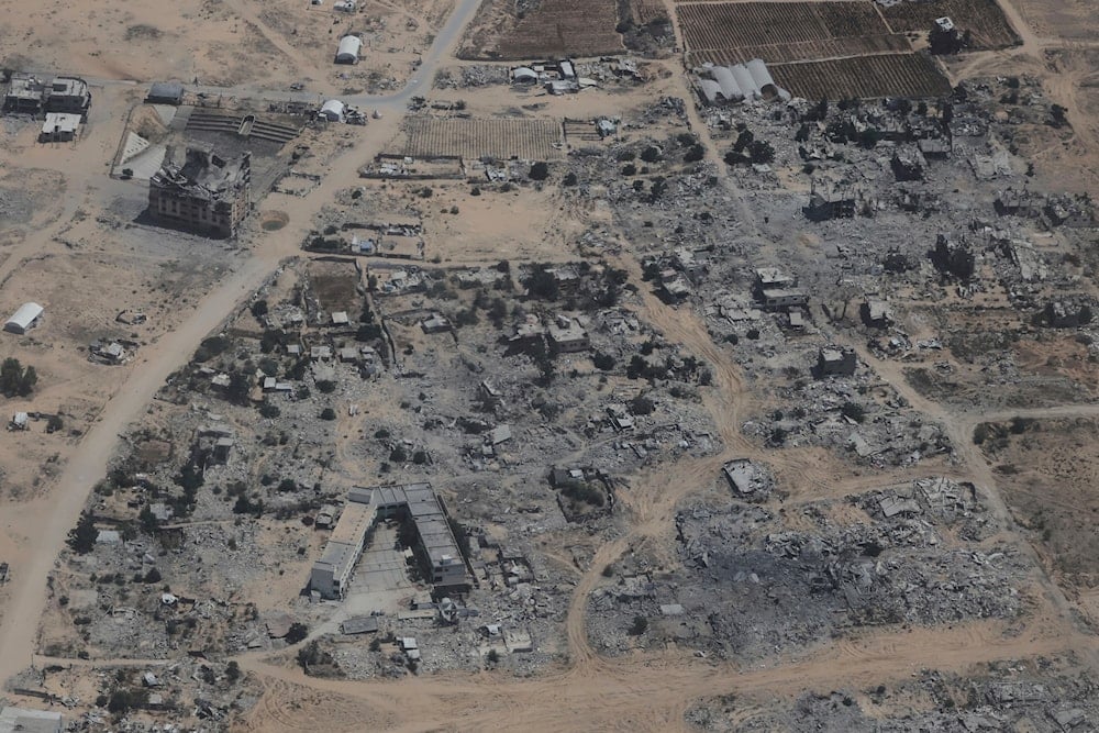 Destroyed buildings in the Gaza Strip are seen from a Jordanian Air Force C-130 plane during an airdrop of humanitarian aid for Palestinians, Gaza, Occupied Palestine, Thursday, Aug. 7, 2025 (AP)
