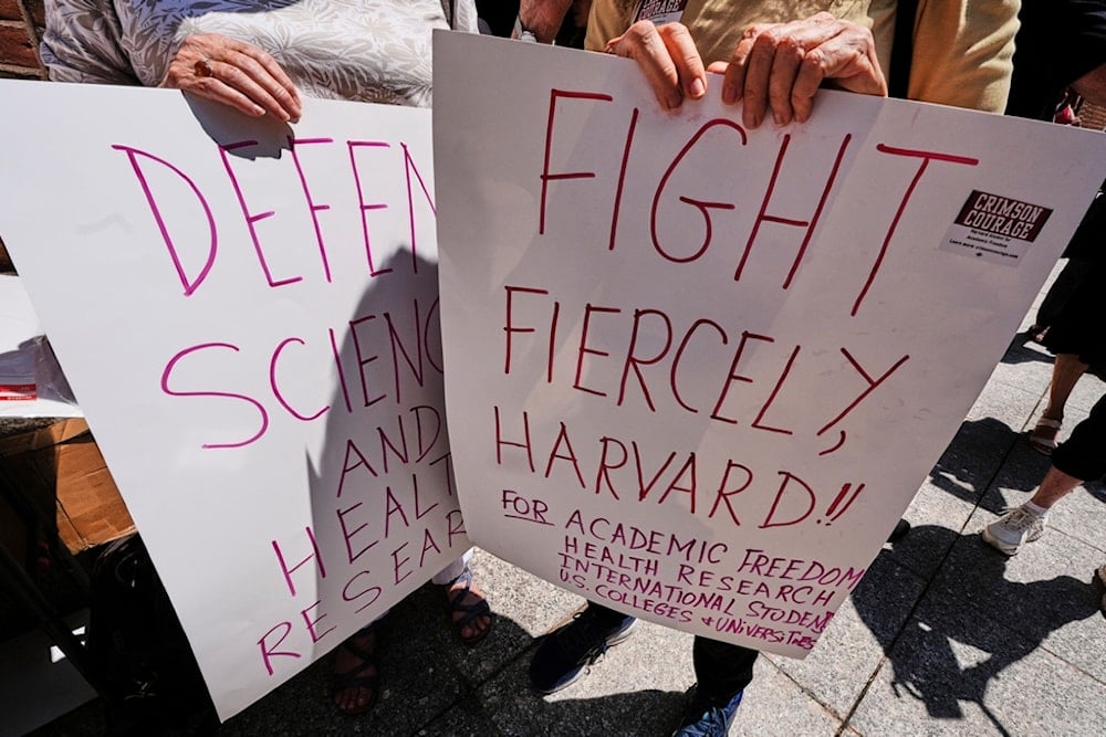 Protestors gather outside the Moakley Federal Courthouse, where Harvard University appeared to challenge $2.6 billion in funding cuts by the Trump administration, Monday, July 21, 2025, in Boston, Massachusetts (AP)
