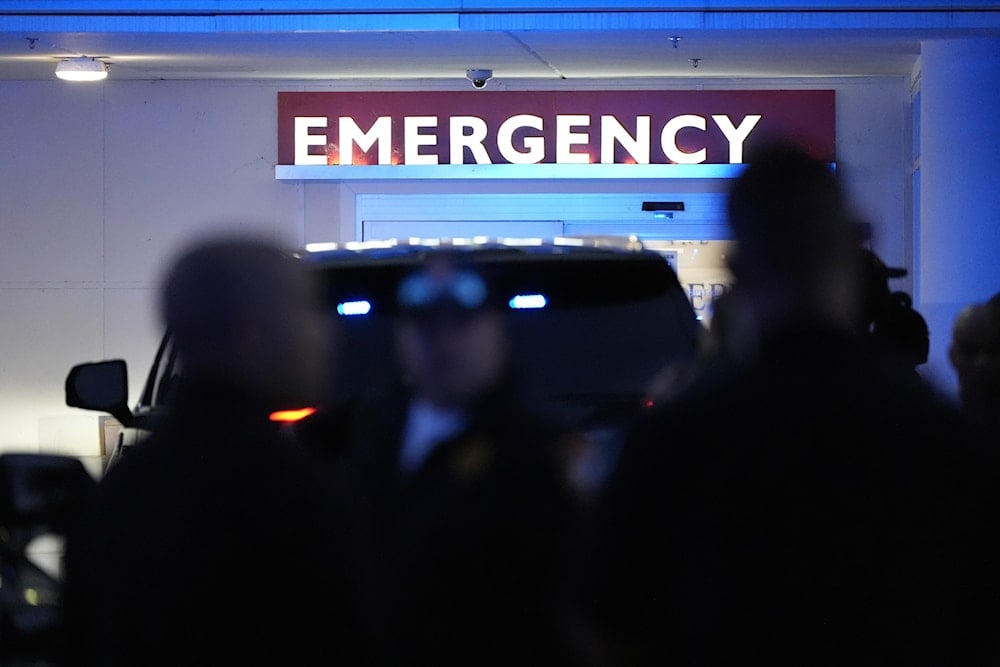 Law enforcements stand outside the hospital emergency after a shooting near the adjoining campuses of the U.S. Centers for Disease Control and Prevention of Emory University in Atlanta on Friday, Aug. 8, 2025 (AP)