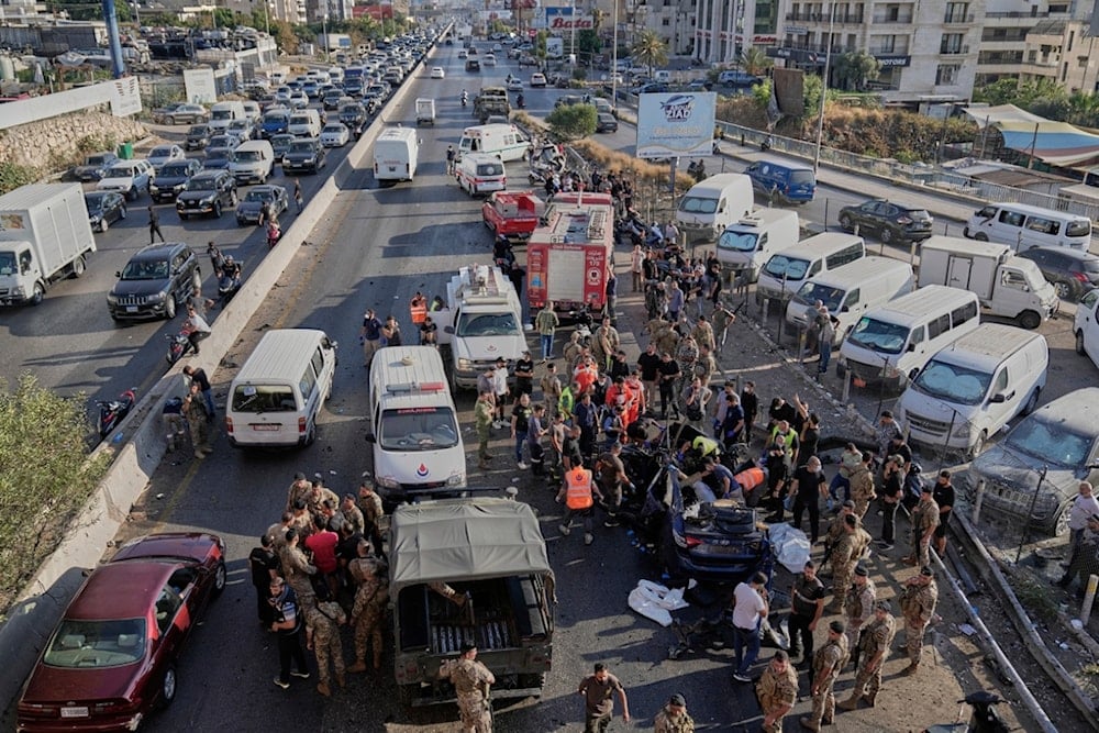 Civil Defense workers and Lebanese army gather around a destroyed car that was hit in an Israeli drone strike in Khaldeh town, south of Beirut, Lebanon, Thursday, July 3, 2025 (AP)
