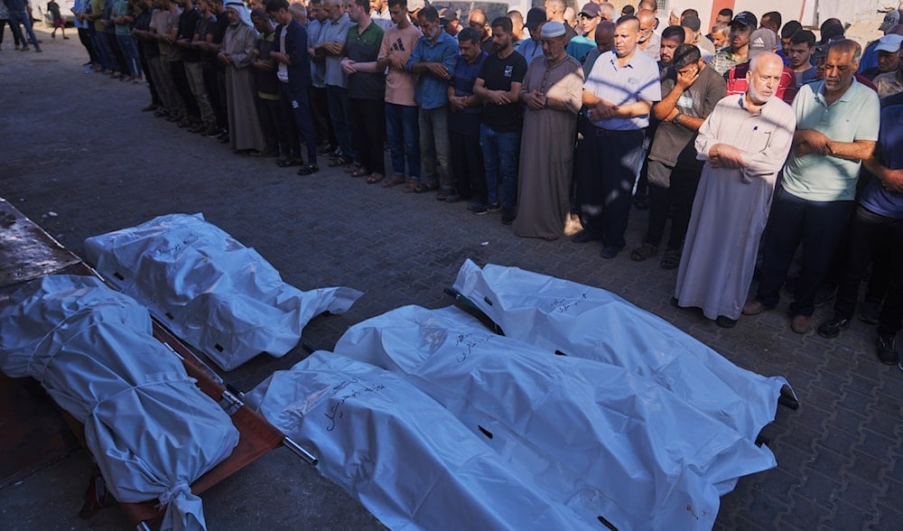 Palestinians pray over the bodies of people killed in an Israeli military strike as they gather outside Al-Aqsa Hospital in Deir al-Balah, in the central Gaza Strip, Monday, Sept. 1, 2025. (AP)