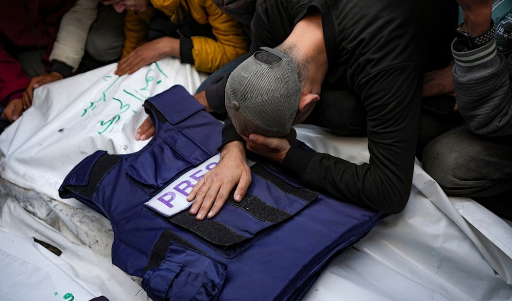 A relative mourns over the body of one of the five Palestinian journalists who were killed by an Israeli airstrike in Gaza City at the Al-Aqsa Hospital in Deir al-Balah, Thursday, Dec. 26, 2024. (AP)