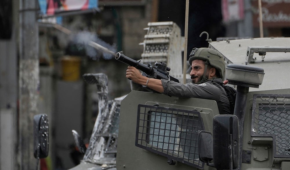 An Israeli occupation soldier fires tear gas during a military raid in the West Bank city of Nablus, Wednesday, Aug. 27, 2025. (AP)