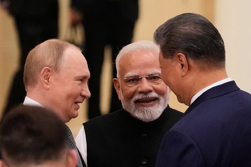Russian President Vladimir Putin, Indian Prime Minister Narendra Modi, and Chinese President Xi Jinping talk ahead of the SCO summit at the Meijiang Convention and Exhibition Center in Tianjin, China, Monday, Sept. 1, 2025. (Pool Photo via AP)