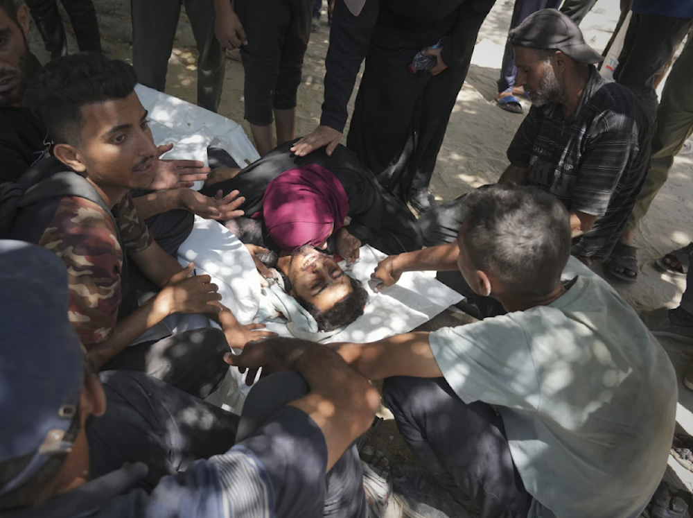 Palestinians mourn over the body of a killed Palestinians child on July 20, 2025. (AP)