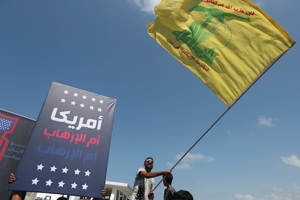 A Shiite man waves Hezbollah flag during a protest against Tom Barrack, US President Donald Trump's envoy to the Middle East, Wednesday, Aug. 27, 2025 (AP)