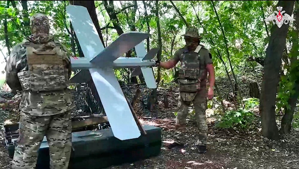 In this photo taken from video distributed by Russian Defense Ministry Press Service on Wednesday, July 23, 2025, Russian soldiers prepare a Lancet drone for action in an undisclosed location in Ukraine (AP)