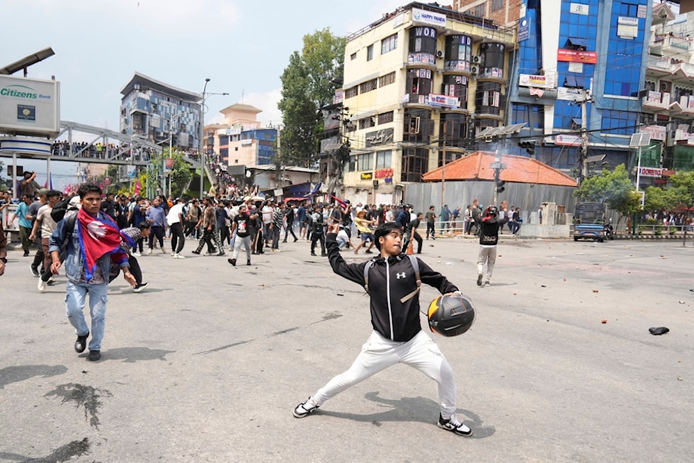 Protestors clash with the riot police outside the Parliament building in Kathmandu, Nepal, Monday, September 8, 2025. (AP Photo/Niranjan Shrestha)