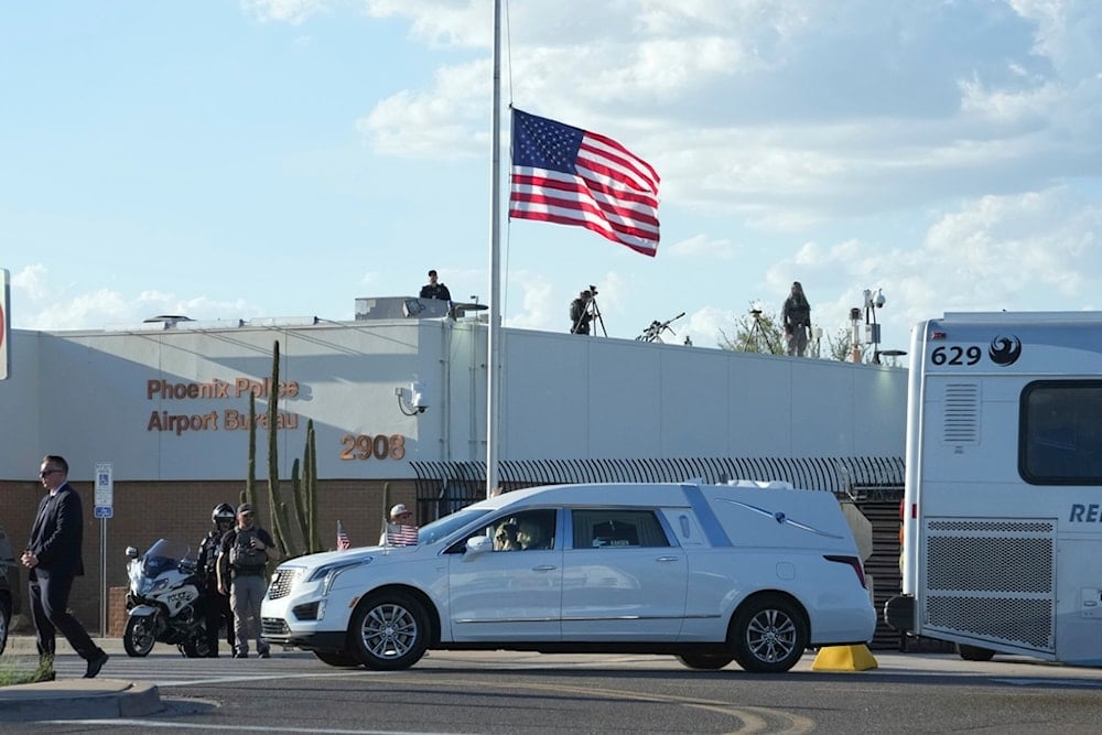 A hearse containing the body of Charlie Kirk leaves after being removed from Air Force Two at Phoenix Sky Harbor International Airport, Thursday, September 11, 2025, in Phoenix (AP)