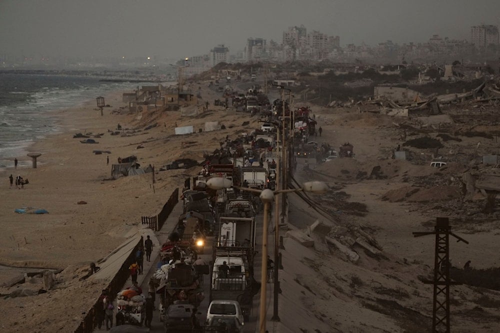 Displaced Palestinians fleeing northern Gaza carry their belongings along the coastal road toward southern Gaza, Thursday, September 11, 2025 (AP)