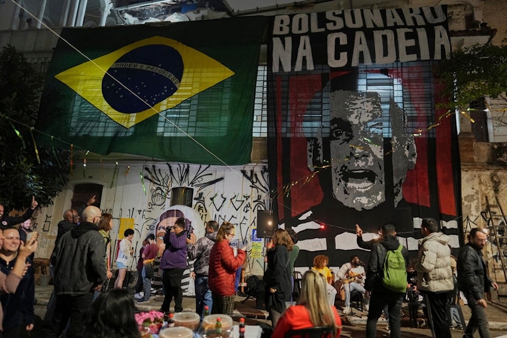 Opponents of former President Jair Bolsonaro celebrate after the Supreme Court sentenced him to more than 27 years in prison for attempting a coup to remain in office despite his 2022 electoral defeat, in Sao Paulo, Friday, September 12, 2025 (AP)