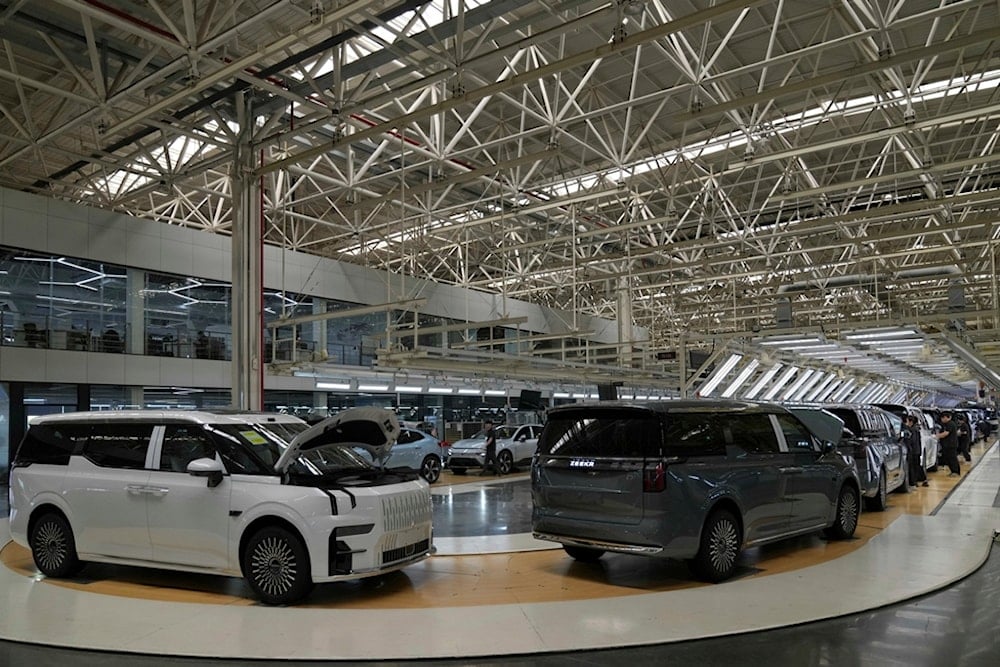 Workers perform final check on Zeekr EV models at the Chinese automaker Zeekr assembly plant, in Ningbo, east China's Zhejiang Province on April 16, 2025. (AP Photo/Andy Wong)