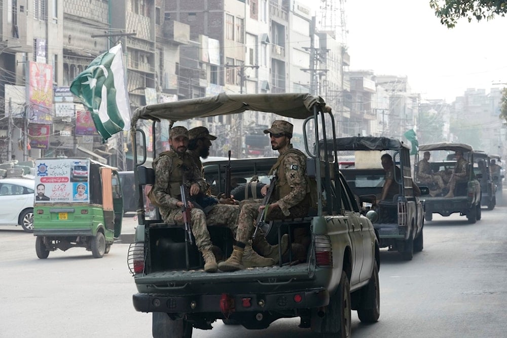 Pakistan army troops patrol to ensure security near the Shiite Muslims attending Muharram procession in Lahore, Pakistan, Friday, July 4, 2025. (AP Photo/K.M. Chaudary)