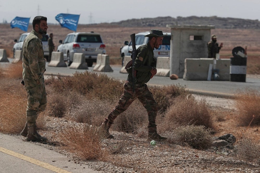 A convoy of UN vehicles crosses a Syrian government forces checkpoint, heading to Sweida city southern Syria, Thursday, August 28, 2025, to distribute humanitarian aid (AP)