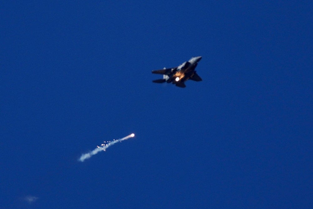 An Israeli Air Force fighter jet releases flares over the Gaza Strip, is seen from southern occupied Palestine, Thursday, May 8, 2025 (AP)