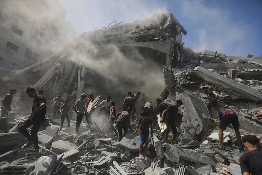 Palestinians search for wood to sell or use for cooking amid the rubble of a building hit by an Israeli strike in Gaza City, Sunday, September 14, 2025 (AP)