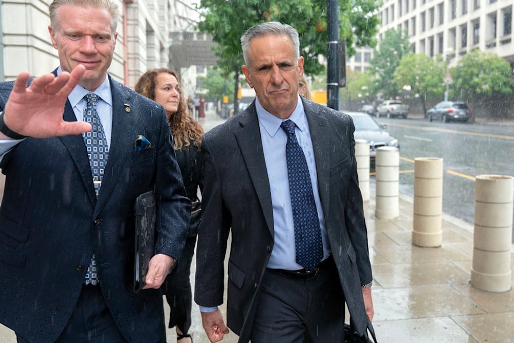 Retired Admiral Robert P. Burke, 63, right, accompanied by his attorney, walks out of the federal courthouse after being sentenced to six years in prison for his conviction on corruption charges, Tuesday, September 16, 2025, in Washington (AP)