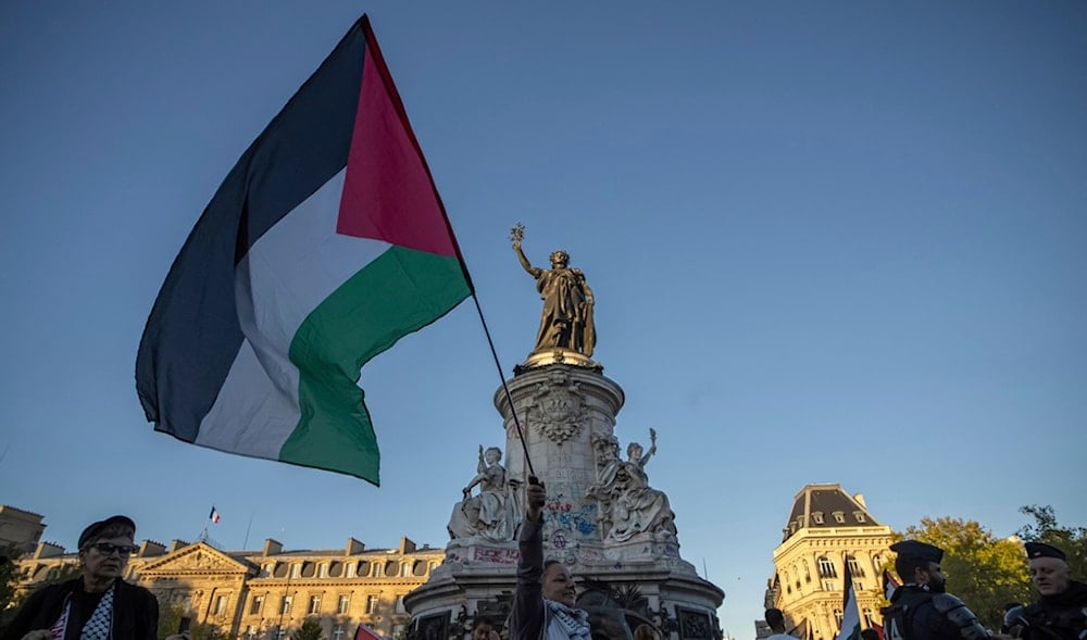 A woman holds a Palestinian flag during a pro-Palestinian gathering at Republic square in Paris, Wednesday, Sep. 17, 2025. (AP)