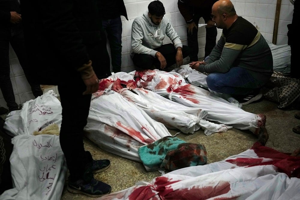 Relatives stand around the bodies of Palestinians killed in the Israeli bombing of the Nusseirat refugee camp in the Gaza Strip at Al Aqsa Hospital in Deir al Balah on Sunday, February 11, 2024. (AP Photo/Adel Hana)