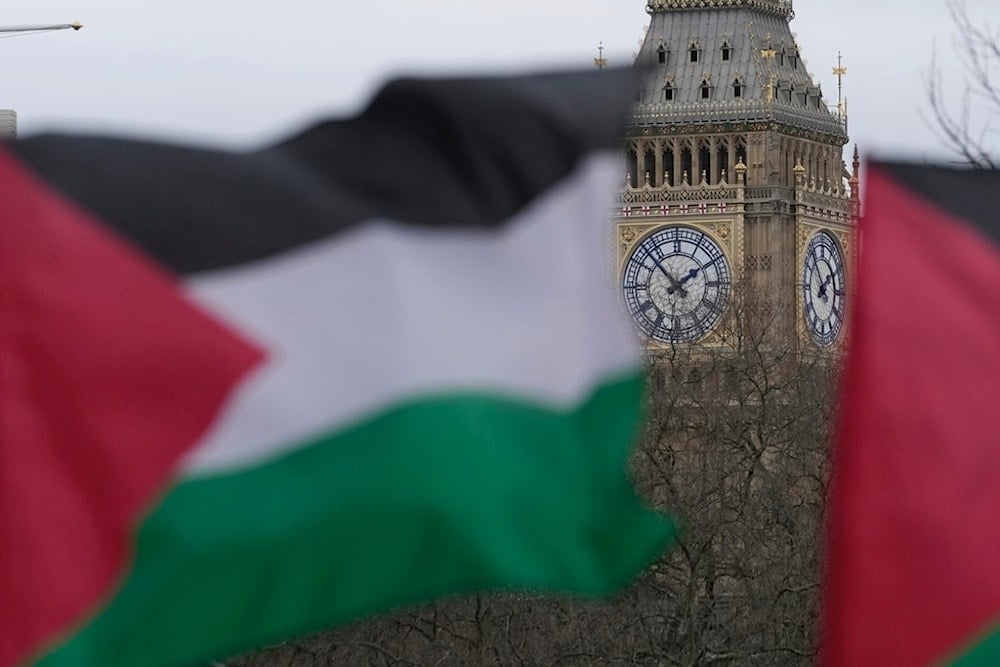 Pro-Palestinian protesters hold up flags during a demonstration in London, Saturday, Feb. 3, 2024 as they demand for a full cease fire and an end to the siege of Gaza. (AP Photo/Kin Cheung)