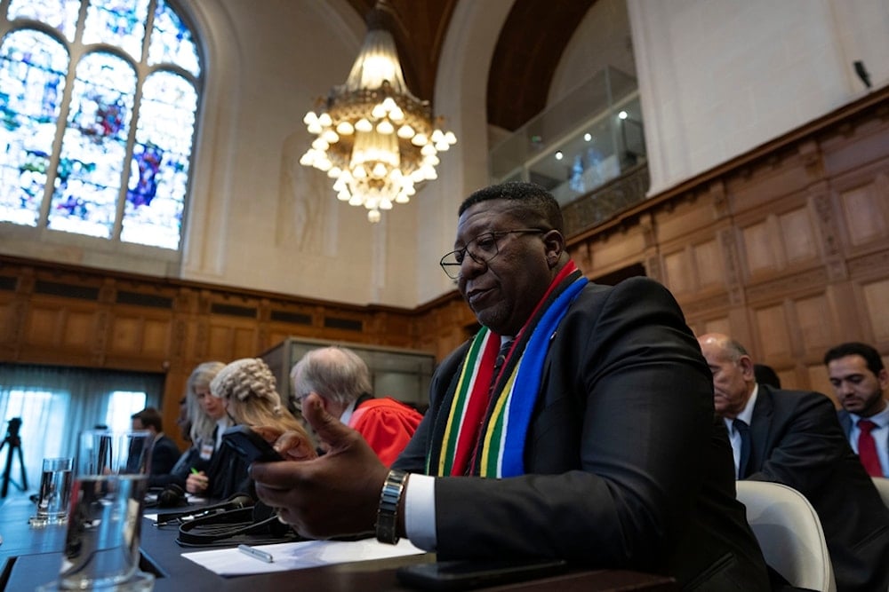 Ambassador of the Republic of South Africa to the Netherlands, Vusimuzi Madonsela, wait for judges to enter the International Court of Justice, or World Court, in The Hague, Netherlands, Friday, May 24, 2024 (AP)