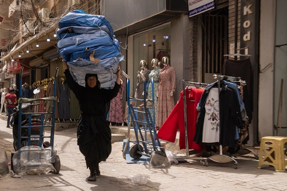 A woman walks in the main Shurja market in central Baghdad, Iraq, Thursday, April 10, 2025. (AP Photo/Hadi Mizban)