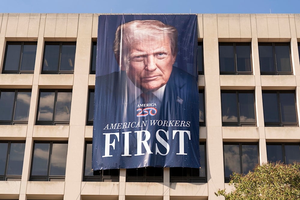 A portrait of President Donald Trump hangs on the Labor Department headquarters near the Capitol in Washington, Friday, Aug. 29, 2025 (AP)