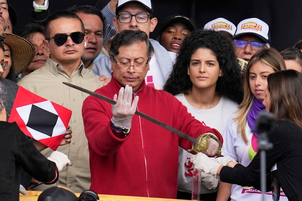 President Gustavo Petro holds a sword that once belonged to independence hero Simón Bolívar during a speech to supporters outside Congress in Bogotá, Colombia, Thursday, May 1, 2025 (AP)