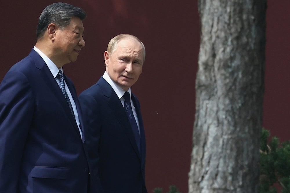 Russian President Vladimir Putin, speaks with Chinese President Xi Jinping during a walk at the Zhongnanhai leadership compound in Beijing, China, Tuesday, Sept. 2, 2025 (AP)