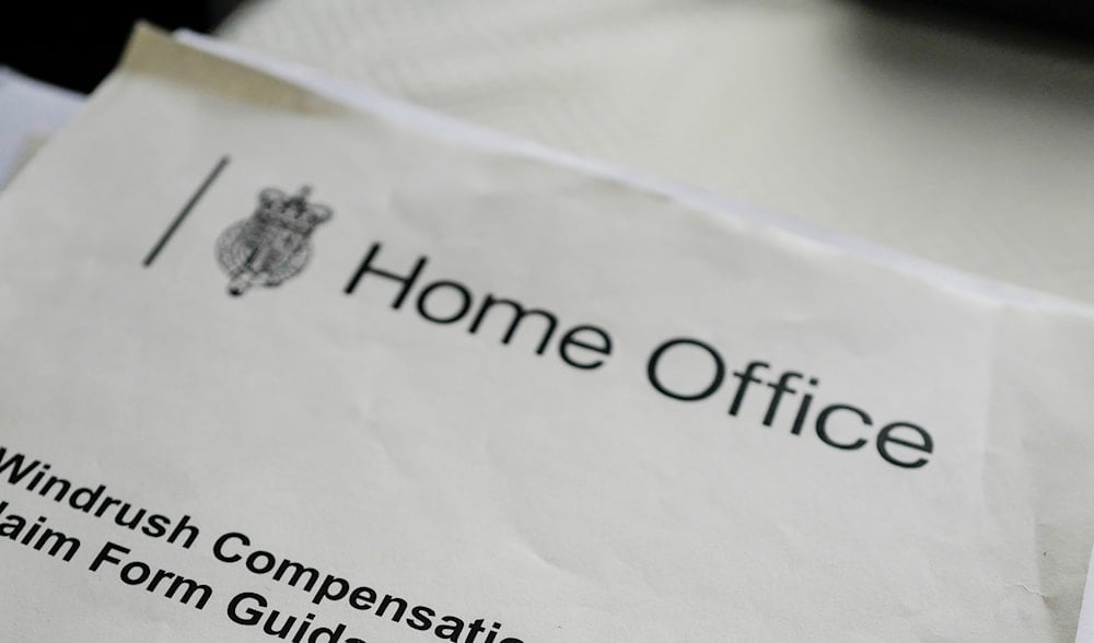 The front page of a folder of documents from Britain's Home Office on the table of Thomas Tobierre, in Essex, England, Tuesday, June 20, 2023 (AP)
