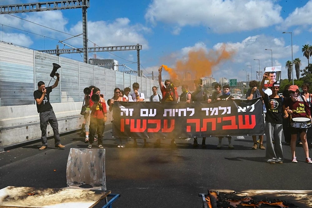 Israeli demonstrators hold a banner and block the Ayalon Highway in Tel Aviv, Occupied Palestine, September 2, 2025 (social media)