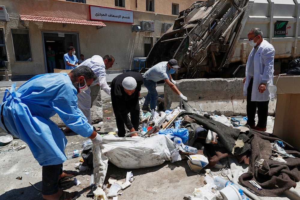 Workers clean the National Hospital following last week's sectarian clashes in the Druze-majority town of Sweida, Syria, on Friday, July 25, 2025 (AP)