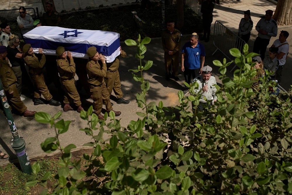 Israeli soldiers carry the coffin of an Israeli soldier who was killed in a shooting operation at the Allenby Bridge Crossing during his funeral at the Mount Herzl military cemetery in occupied al-Quds, Friday, September 19, 2025 (AP)