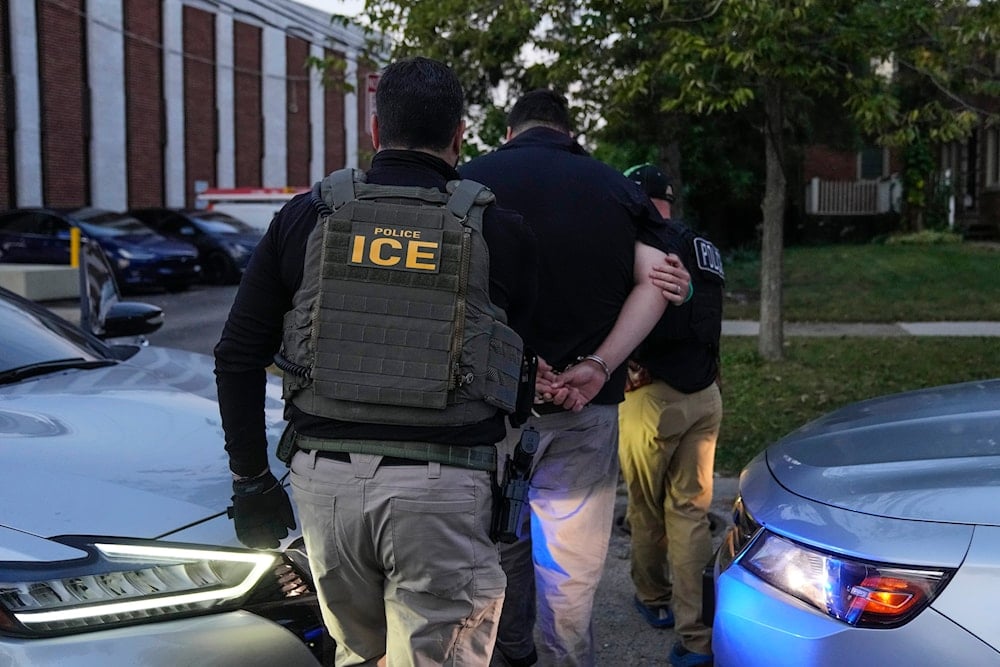 US Immigration and Customs Enforcement agents make an arrest during an early morning operation in Park Ridge, Ill., Friday, Sept. 19, 2025 (AP)