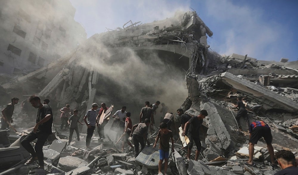 Palestinians search for wood to sell or use for cooking amid the rubble of a building from which thousands of artifacts were removed before being destroyed in an Israeli strike in Gaza City, Sunday, Sept. 14, 2025. (AP)