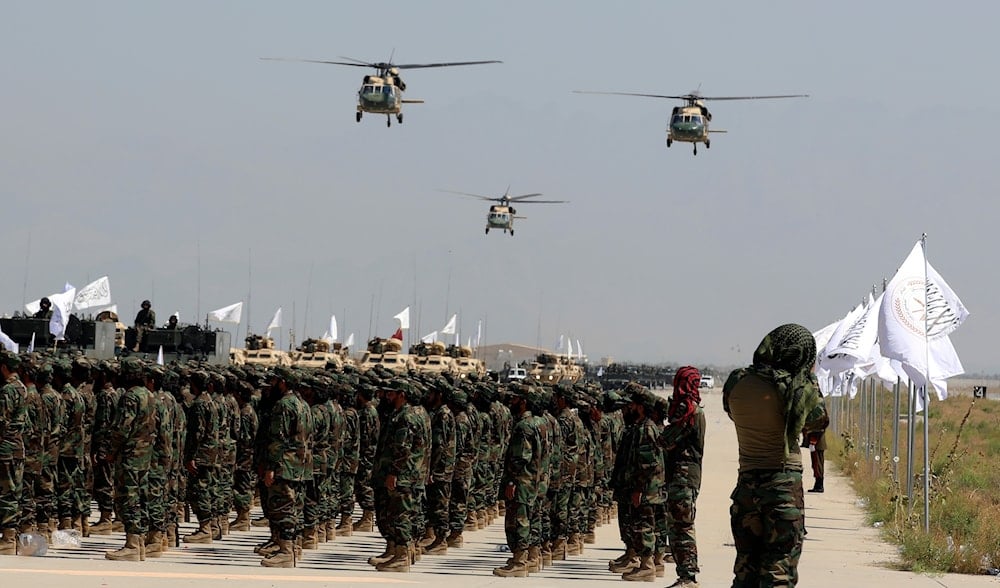 UH-60 Black Hawk helicopters fly during a military parade to mark the third anniversary of the withdrawal of U.S.-led troops from Afghanistan, in Bagram Air Base in the Parwan Province of Afghanistan, Wednesday, Aug. 14, 2024. (AP)
